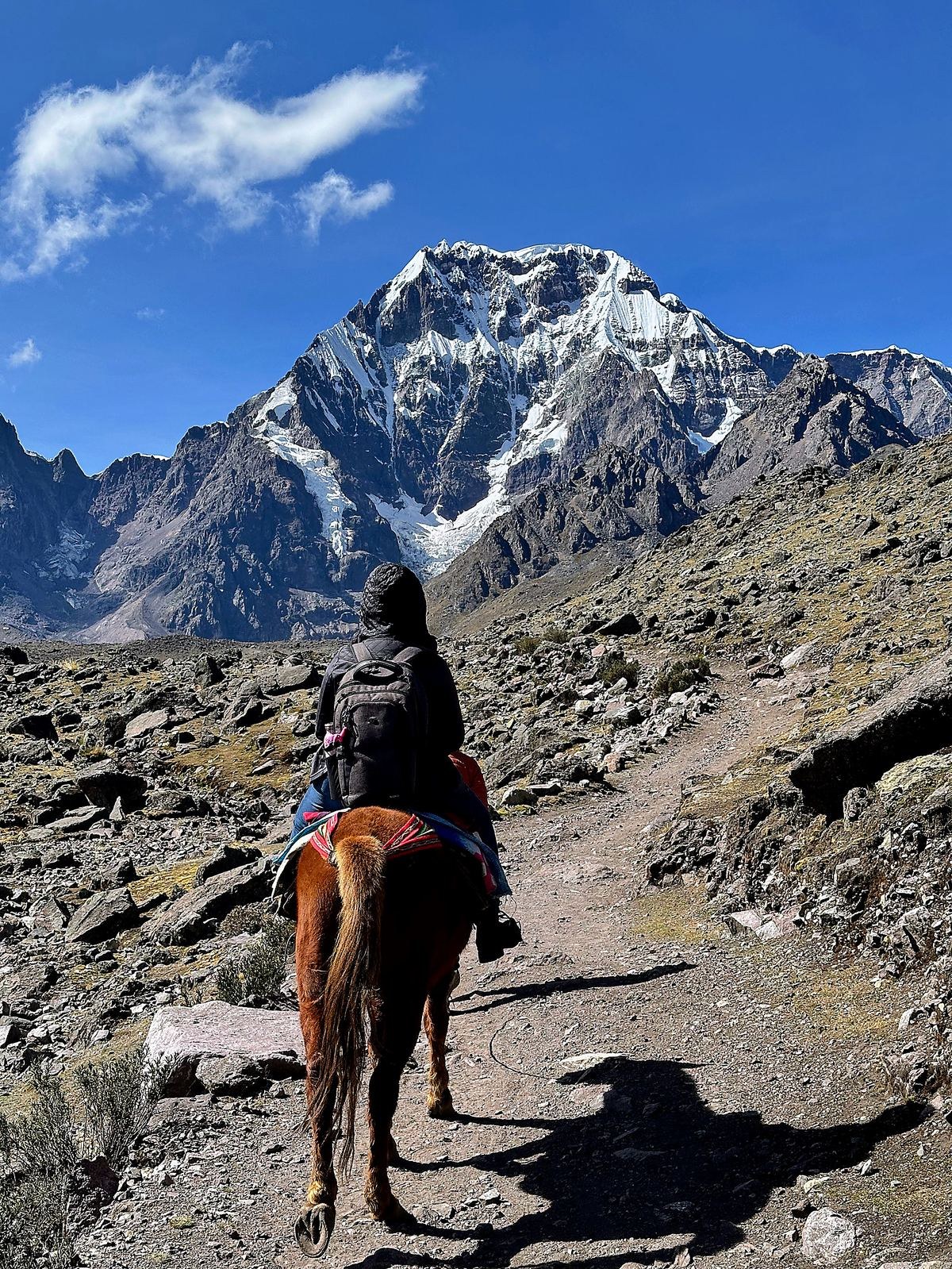 Trekking on horseback toward an Andean peak